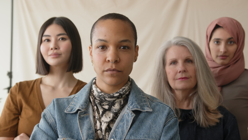 Slow motion of mid adult mixed race LGBTQ woman in support of International Women's Day with multi ethnic female friends | Shutterstock HD Video #1086912107