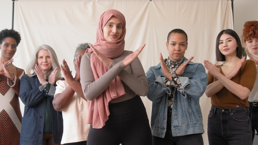 Slow motion dolly in of Middle Eastern woman wearing hajib gesturing Break The Bias in support of International Women's Day with female friends | Shutterstock HD Video #1086912128