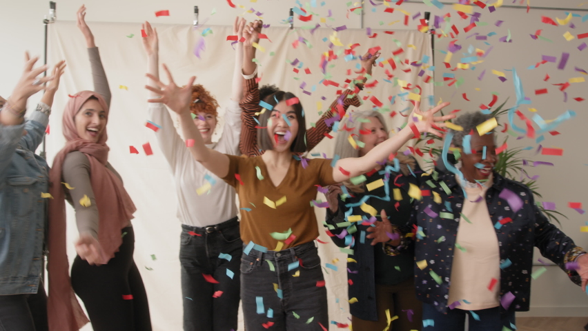 Slow motion of cheerful multi ethnic women celebrating and dancing with ticker tape falling | Shutterstock HD Video #1086912137