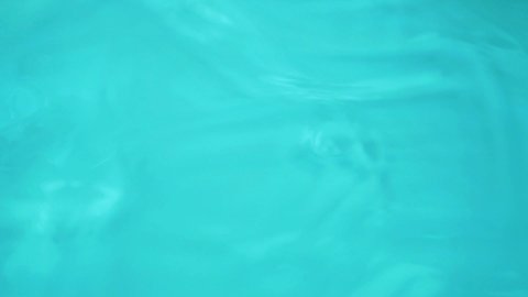 Surface of Clear Blue Water in Sunbeams, Ripples and Waves on Water, Pool, Sea, Ocean. Abstract Background from Pure Blue Water.