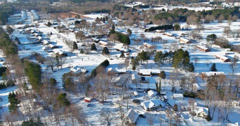 Aerial view snow covered streets, private properties idyllic town covers roofs asphalt roads leading through tranquil suburbs in USA