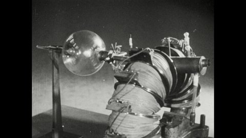 1940s: Animated radiation particles pass through field on mass spectrograph. Magnetic field bends radioactive particles near photographic plate.