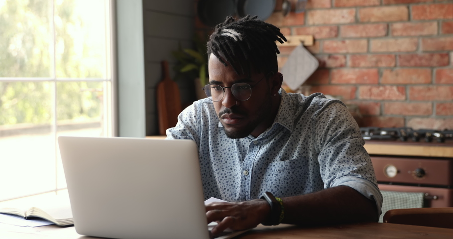 Irritated nervous Black man hipster remote employee read error message on laptop screen puzzled with unexpected problem bad online service work. Stressed young guy student get email about fail on exam Royalty-Free Stock Footage #1086926636