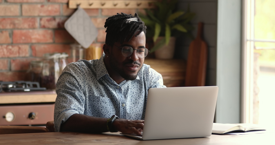 Black guy student check exam result in elearning app on pc excited with getting high grade scholarship. Amazed young hipster man clap hands yell yes by laptop celebrate admission to college university Royalty-Free Stock Footage #1086926885