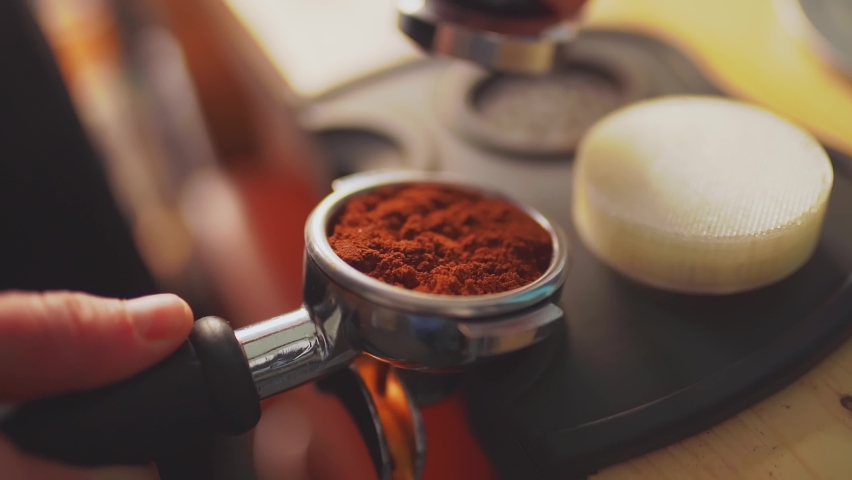 4k, barista tempering ground coffee into espresso pitcher, slow motion | Shutterstock HD Video #1086930026