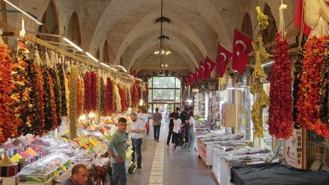Gaziantep, Turkey - October 25, 2021: Old bazaar Zincirli Bedesten in Gaziantep old town. Souvenir shops, copper items,various spices for sale on the historic covered market. Steadicam footage