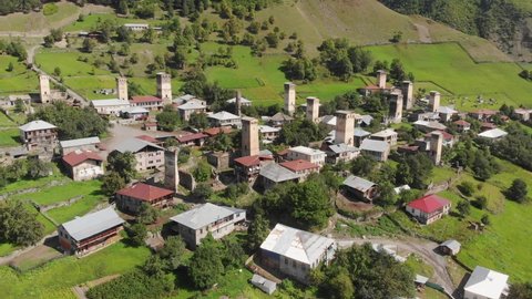 Aerial drone view of the village with traditional Svan towers in Caucasus mountains in Svaneti region of Georgia. Svan towers are historic tower houses built as defensive dwellings in remote location