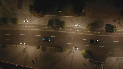 Aerial view of night streets in downtown Bucharest, Romania, with bright night illumination. cars drive through the streets of the night city. Wide shot with smooth cinematic drone motion. 4k footage