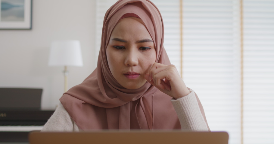 Asia people young adult west arab woman wear hijab scarf worry tired upset in cash flow bad news SME debt crisis impact loan money loss. Job issue work at home feel pain stress think hard tough.