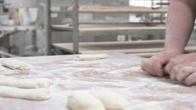 Baker kneading dough in a bakery. High quality 4k footage