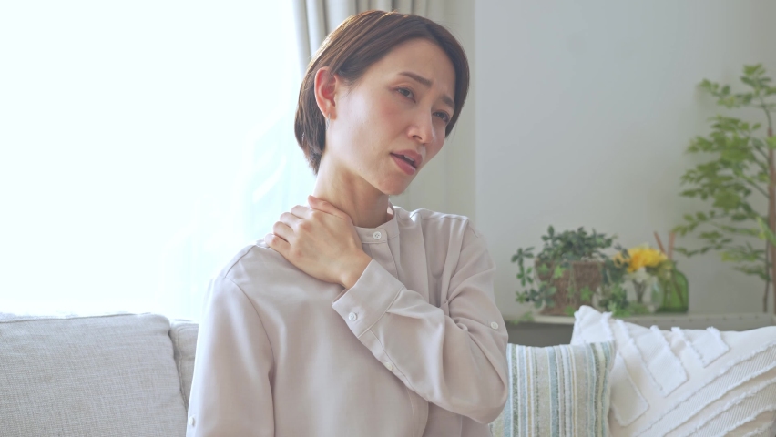 Asian female complaining of stiff shoulders Royalty-Free Stock Footage #1086942716