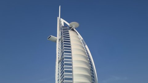 Dubai , United Arab Emirates - 01 31 2022: Burj Al Arab Hotel Skyscraper, Waterfront Landmark, Tilt Down 60fps