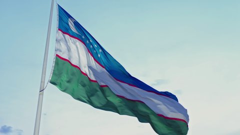 Aerial Panorama to Uzbekistan Flag, Flag motion in wind, Sunset City Tashkent