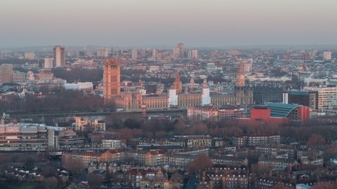Establishing Aerial View Shot of London UK, United Kingdom, Palace of Westminster, British Parliament,  colors of sunrise, beautiful day