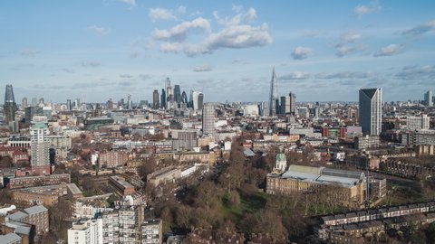 Establishing Aerial View Shot of London UK, United Kingdom, City of London and skyscrapers, slow push in, nice soft clouds in sunny day