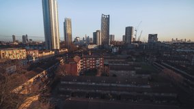 Establishing Aerial View Shot of London UK, United Kingdom, City of London and skyscrapers, golden light, crane rise up shot