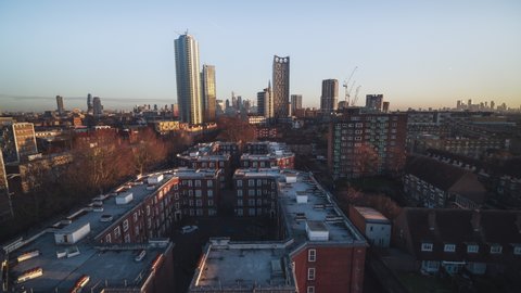 Establishing Aerial View Shot of London UK, United Kingdom, City of London and skyscrapers, push in over council estates, revealing Elephant and Castle 
