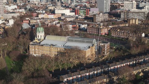 Establishing Aerial View Shot of London UK, United Kingdom, sunny day, golden hour, Imperial War Museum, circling left