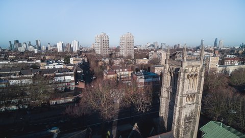 Establishing Aerial View Shot of London UK, United Kingdom, South London, residential area, sunny, push next to church tower