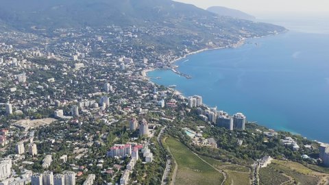 Yalta, Crimea. Panorama of the city in sunny weather. Embankment and port, Aerial View Hyperlapse