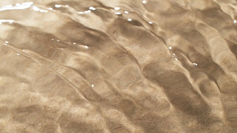 Super slow motion of water waves with sand texture. Filmed on high speed cinema camera, 1000 fps.