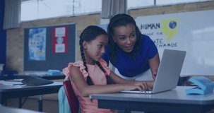 Animation of digital screens over happy african american female teacher and schoolgirl in classroom. education, school and teaching concept digitally generated video.