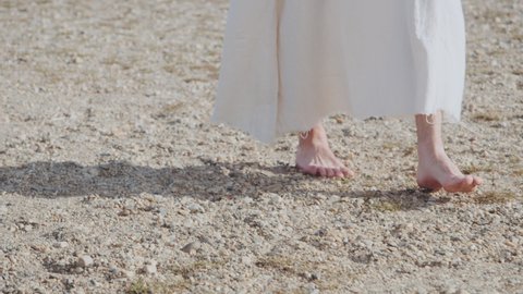 Closeup of Jesus walking on sand at Sea of Galilee Water - Shot on RED camera