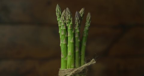 fresh bunch of asparagus tied with rope in a bow and spinning around