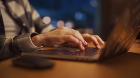 Close Up Footage of Person's Feminine Hands Use Laptop Computer with Diverse LGBT Stickers while Sitting at a Table. Creative Designer in Flannel Shirt Typing on Keyboard, Browsing Internet.