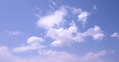Loop features puffy white clouds fly over a deep blue sky in faster time lapse fashion. Shot in 8K, downscale 4K.