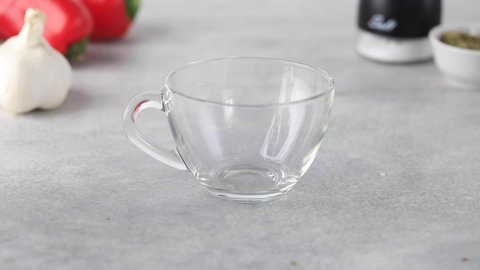 Video. Homemade bone broth is poured into a transparent mug.
