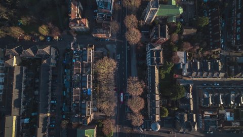 Top Down, Overhead, Establishing Aerial View Shot of London UK, United Kingdom, following double deccker high