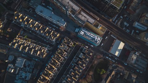 Top Down, Overhead, Establishing Aerial View Shot of London UK, United Kingdom, train passing by