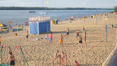 SAMARA, RUSSIA - JUNE 21, 2021: A group of people playing beach volleyball on the sand