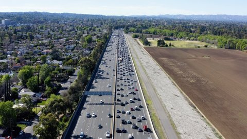 Beautiful aerial panorama of busy traffic on multi-level highway. Aerial view of busy cars with traffic jam in the rush hour on highway road street.  Traffic Jam Aerial View.