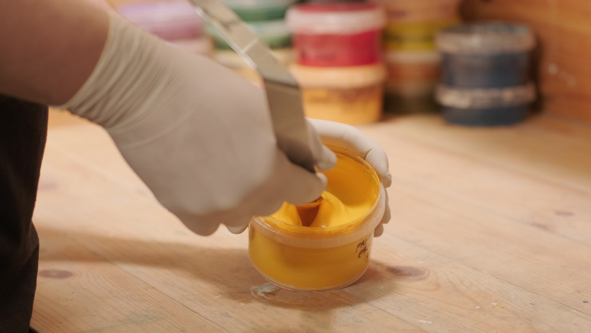A worker kneads the paint for painting the walls