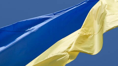 Slow motion of Ukraine flag waving background sky blue and yellow national color Ukrainian yellow-blue. Ukraine flag wind waving national symbol country. Highly detailed fabric texture flag of Ukraine