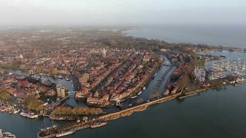 Aerial view on the historic town Enkhuizen in the Netherlands, situated on the edge of the IJsselmeer lake with historic buildings, towers and churches
