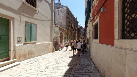 Rovinj, Croatia. - July 9, 2021. Tourists at noon on Vladimira Svalbe Street.