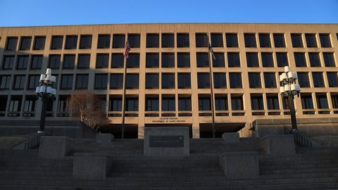 The Frances Perkins United States Department of Labor Building in Washington, D.C in the late afternoon. The camera pans left to right. Shadows are cast across the facade of the building.