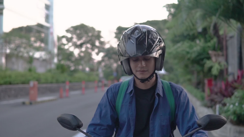 Asian man riding a motorcycle on the street Royalty-Free Stock Footage #1087012664