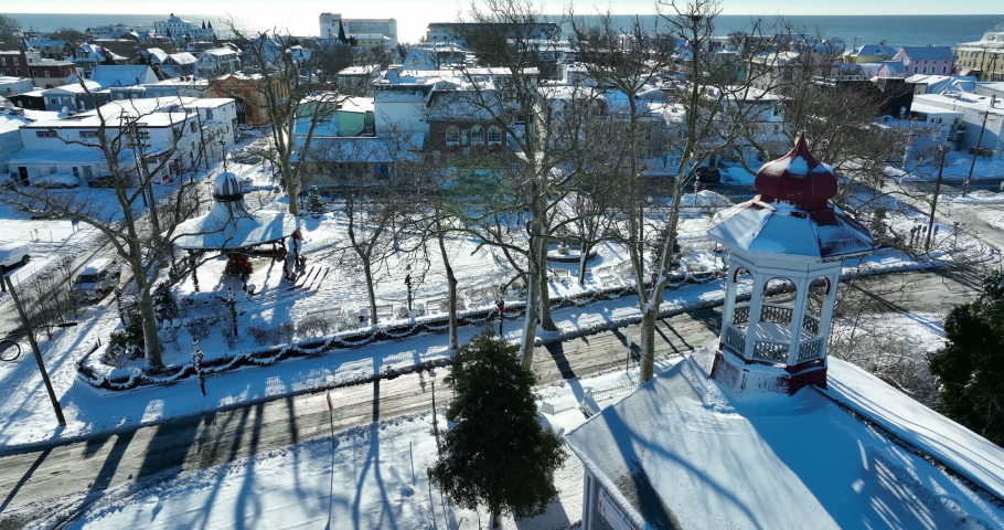 Bell tower covered in snow. Cape May New Jersey snowstorm. Ocean water in distance on horizon.