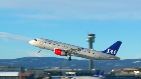 Oslo Airport Norway - February 6 2022: airplane sas airbus 320 take off sunny day