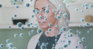 Animation of virus cells over senior caucasian woman coughing. medical and healthcare services during coronavirus covid 19 pandemic concept digitally generated video.