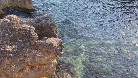Turquoise sea ripples water background. Transparent green sea water surface in tropical paradise lagoon. Beautiful seascape. Rocky coastline of Mediterranean, Calm ocean water. Zen. Relax. Nature.