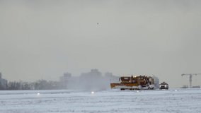 Winter at the airport Snowplows clean the runway in the snow in winter top slow motion video