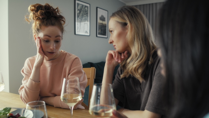 Three serious female caucasian friends chatting over problems of one friend at home. Shot with RED helium camera in 8K | Shutterstock HD Video #1087036223