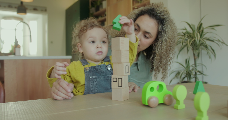 Mother and Toddler at Home in Kitchen Playing