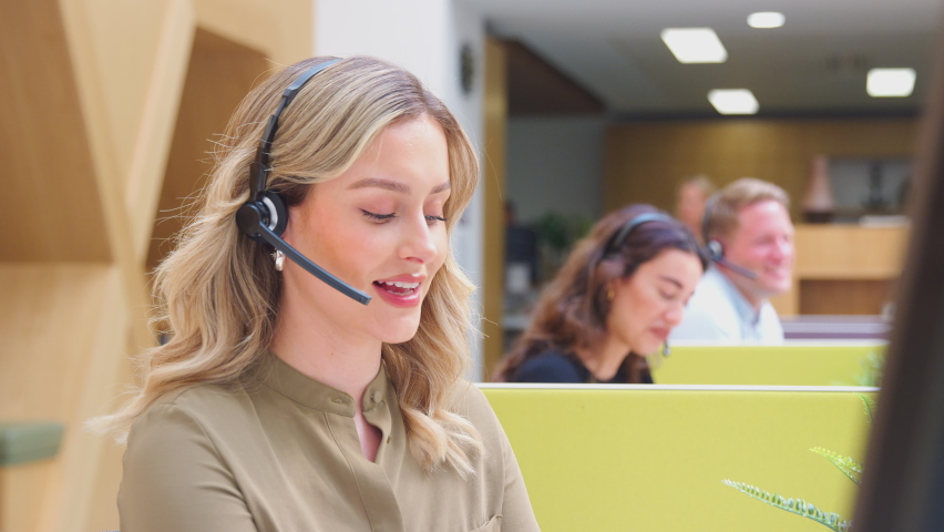 Businesswoman Wearing Phone Headset Talking To Caller In Customer Services Centre Royalty-Free Stock Footage #1087042355