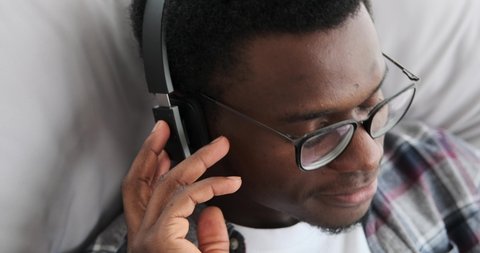 Young man listening music on headphones